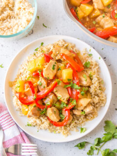 pineapple ginger chicken stir fry over rice on plate