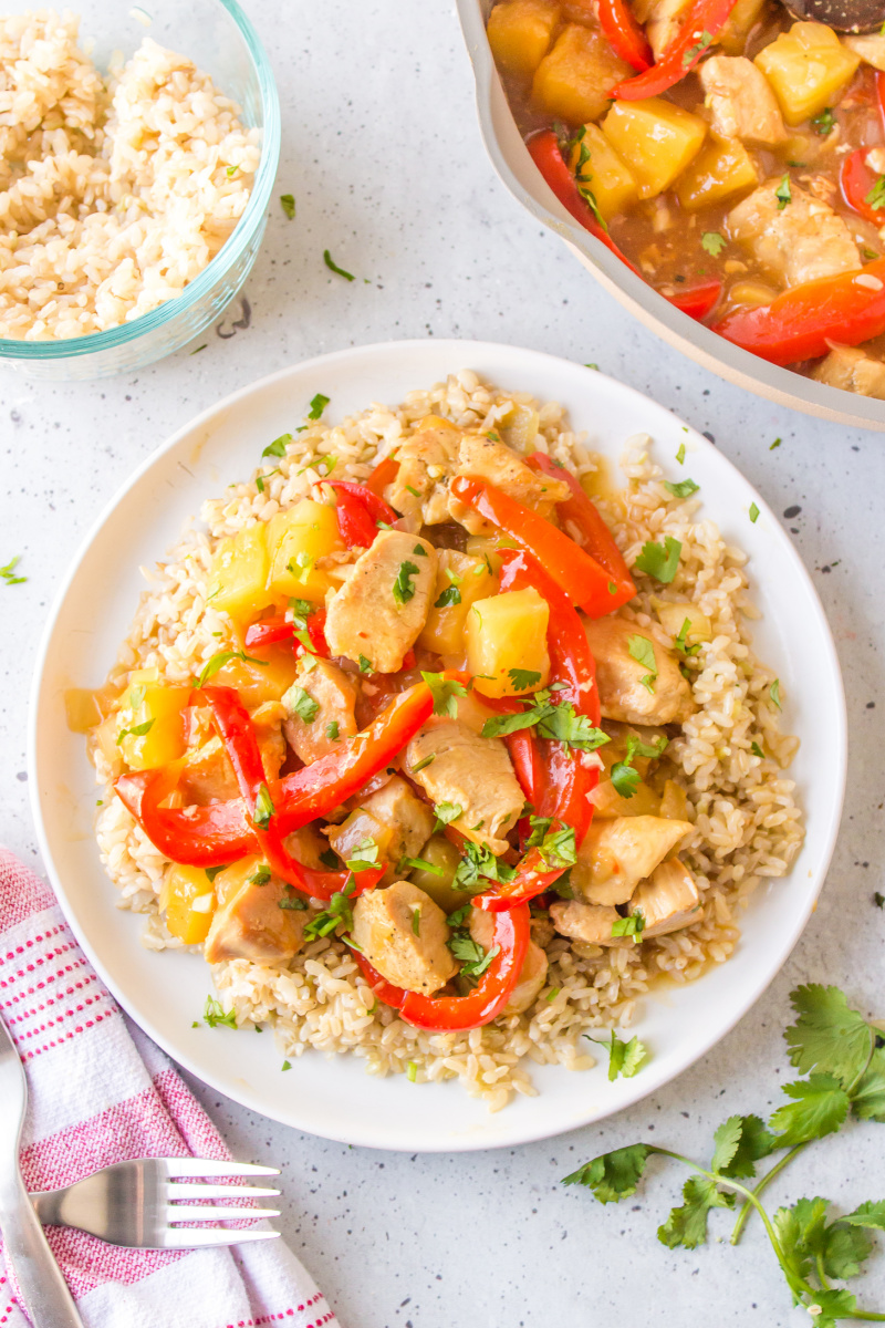 pineapple ginger chicken stir fry over rice on plate