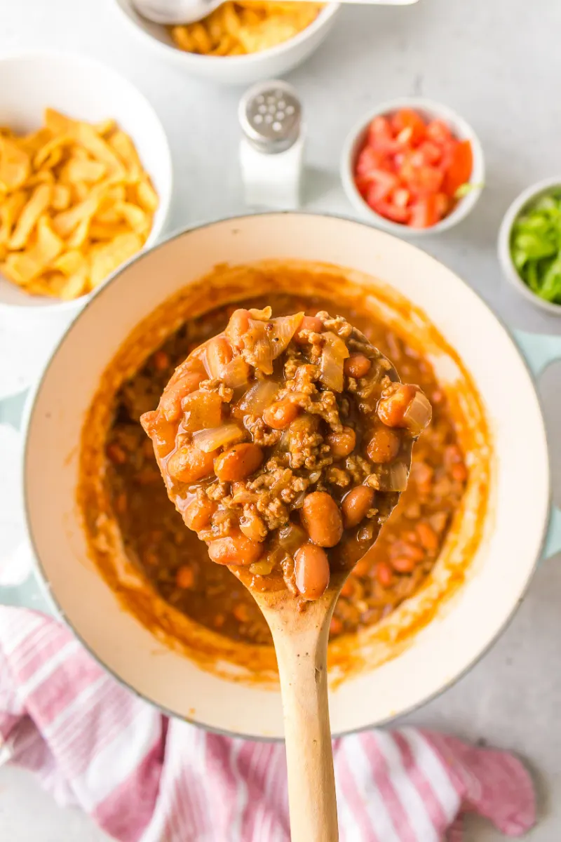spoonful of chili beans over pot
