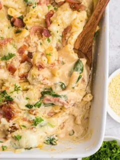 creamy tuscan chicken pasta bake in casserole dish