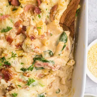 creamy tuscan chicken pasta bake in casserole dish