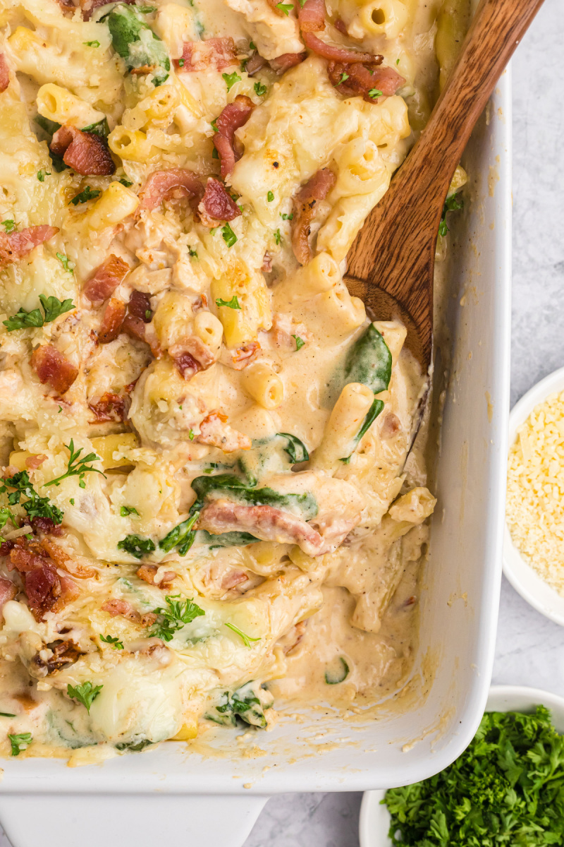 creamy tuscan chicken pasta bake in casserole dish