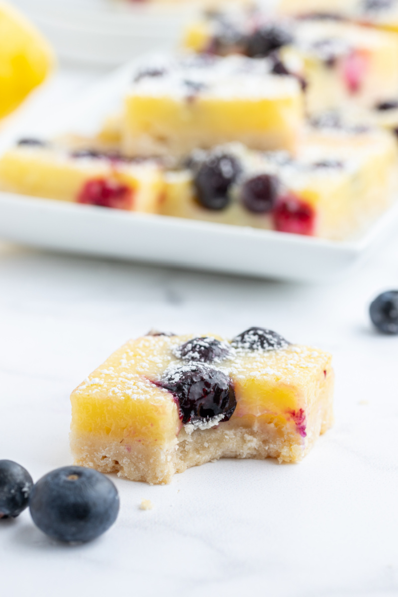 lemon blueberry bar with bite out of it
