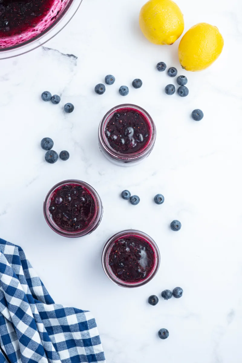 three open jars of blueberry jam