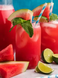watermelon agua fresca in glasses with mint and lime garnish
