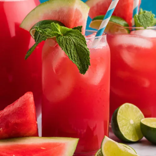 watermelon agua fresca in glasses with mint and lime garnish