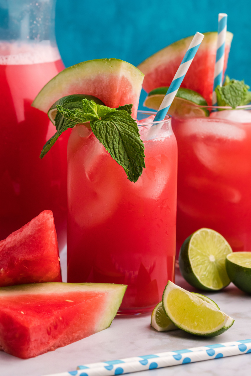 watermelon agua fresca in glasses with mint and lime garnish