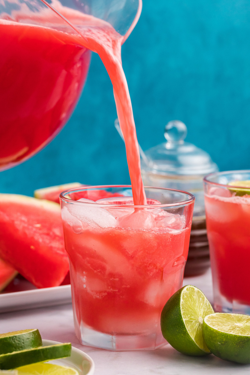 pouring watermelon agua fresca into glass