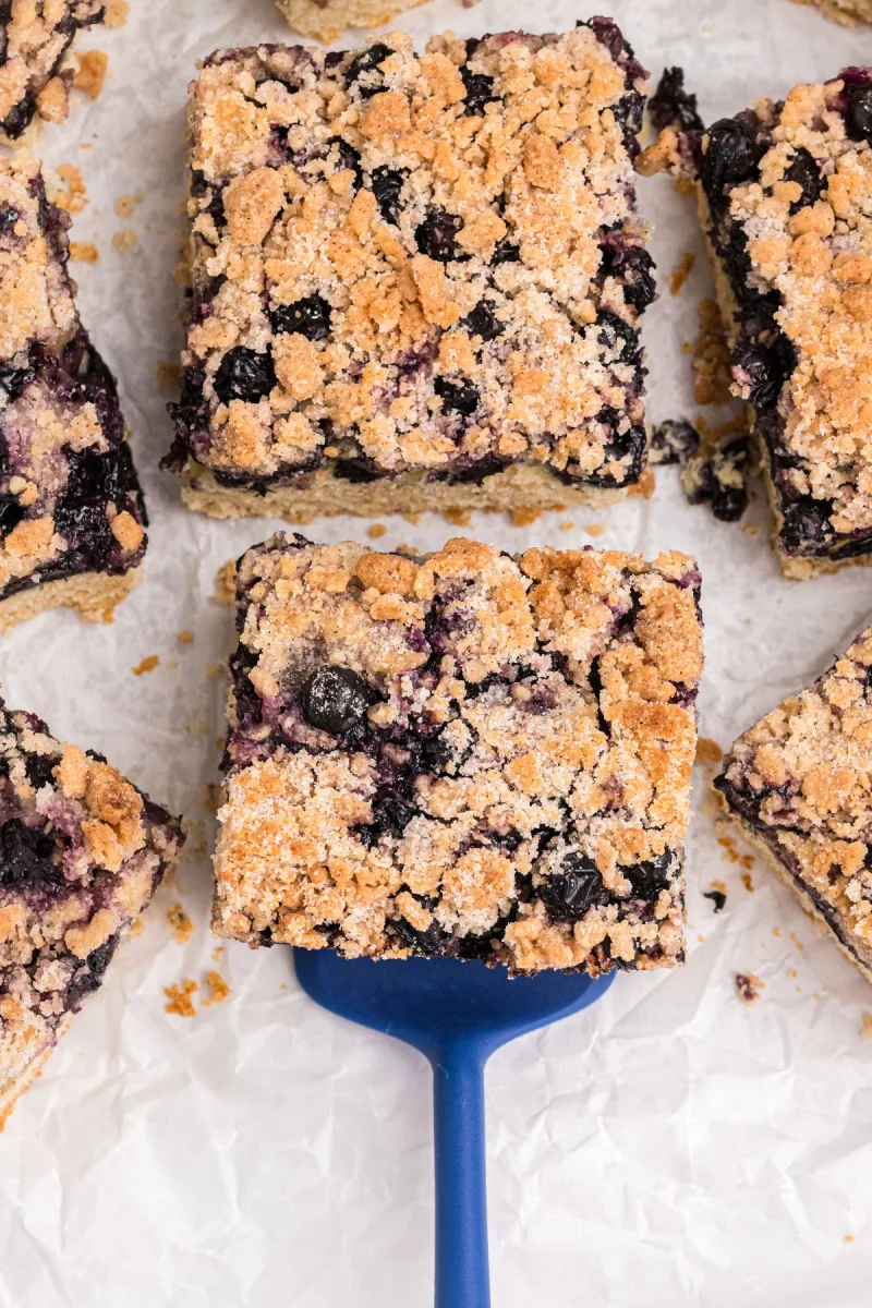 spatula lifting up slice of blueberry buckle