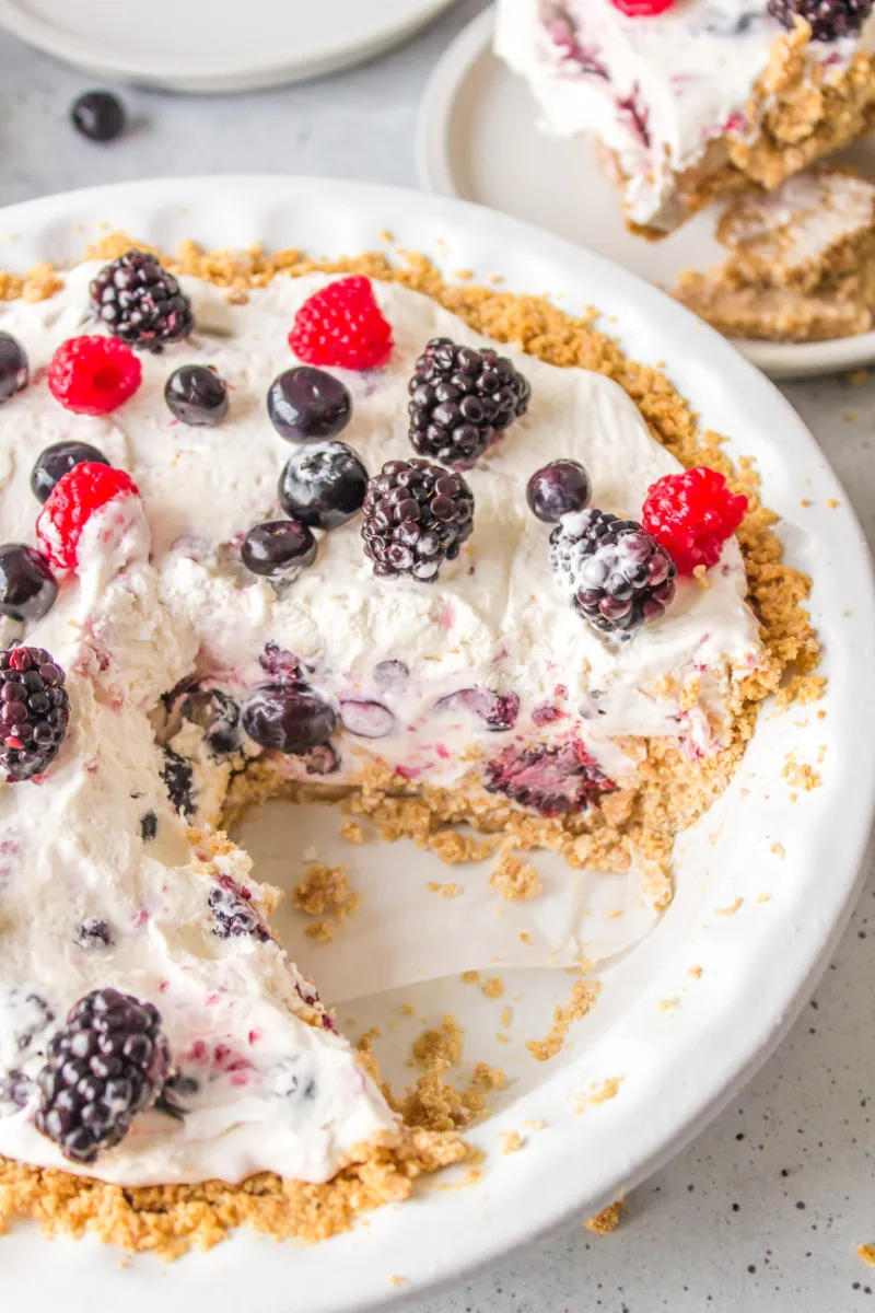 easy no bake berry pie with big slice taken out of it