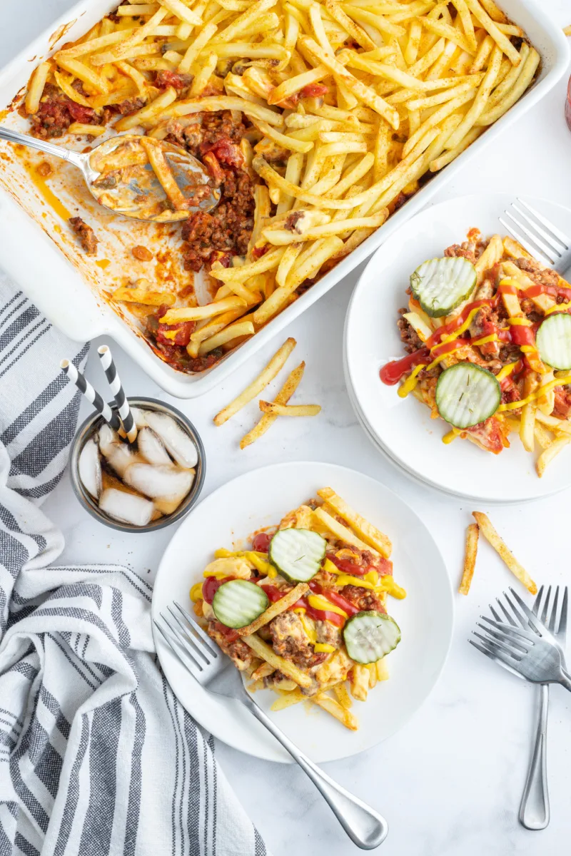 serving of cheeseburger and fries casserole on plate with garnishes