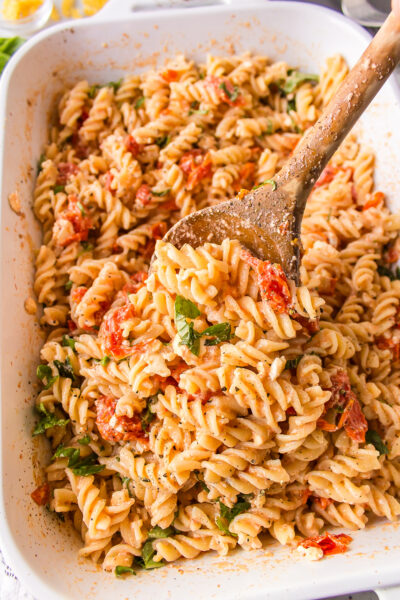 casserole dish of tik tok baked feta pasta with wooden spoon