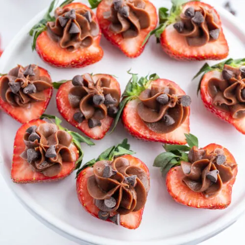 chocolate cheesecake strawberry bites on a platter