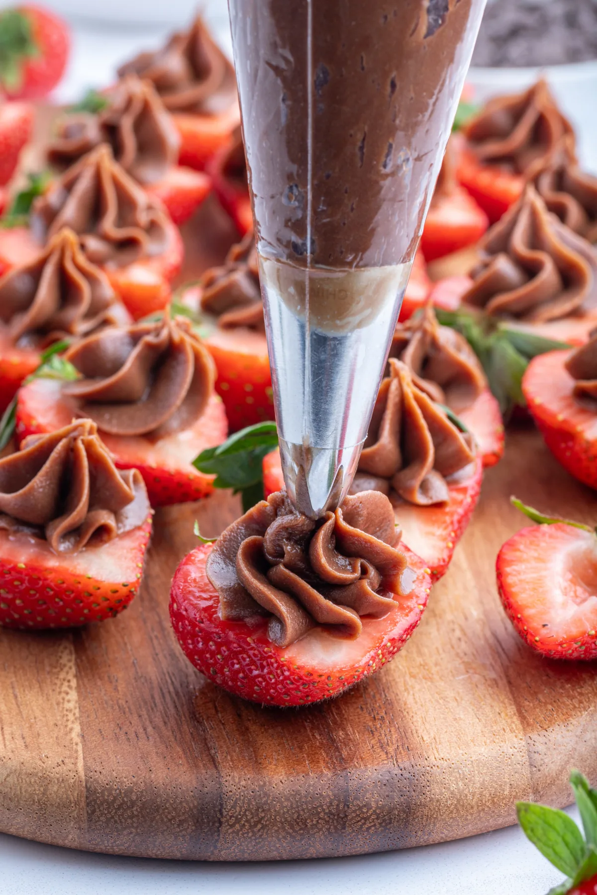 Piping chocolate onto strawberries