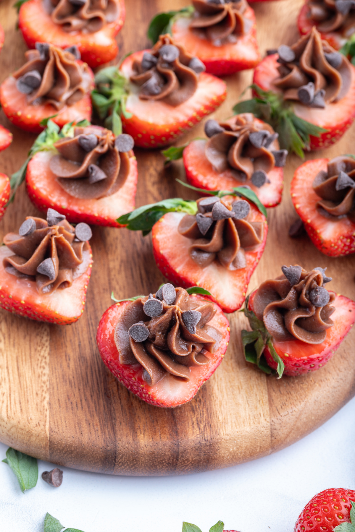 chocolate cheesecake strawberry bites on a board