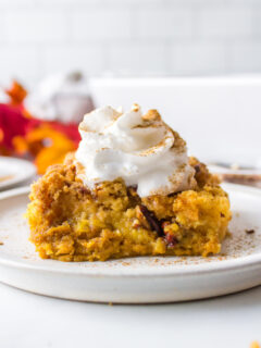 slice of pumpkin dump cake with whipped cream on top