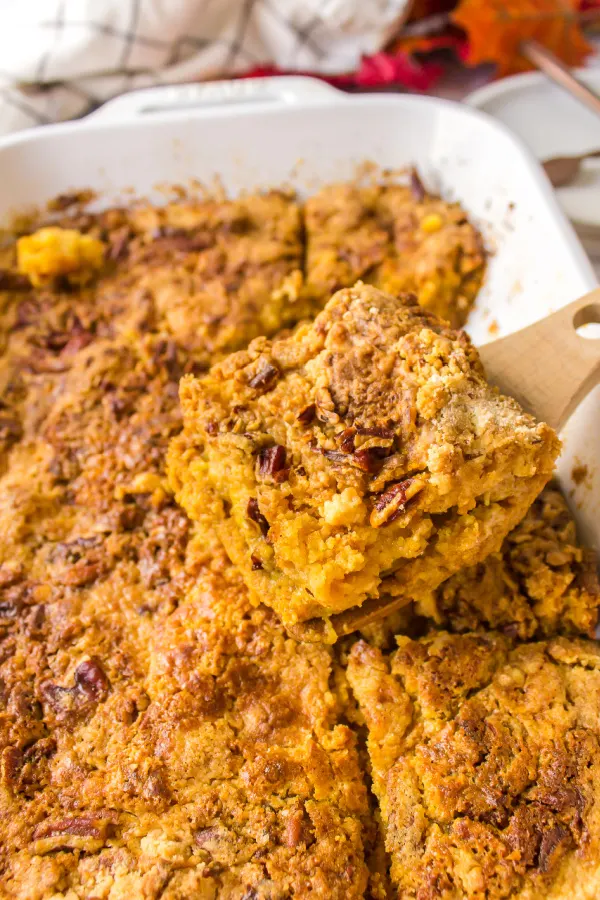 spatula taking out slice of pumpkin dump cake from pan