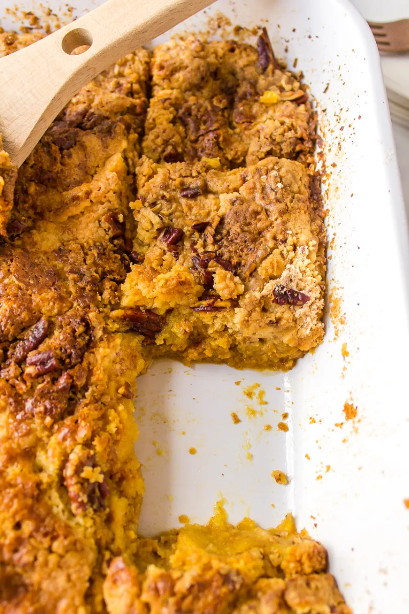 pumpkin dump cake in pan with slice taken out