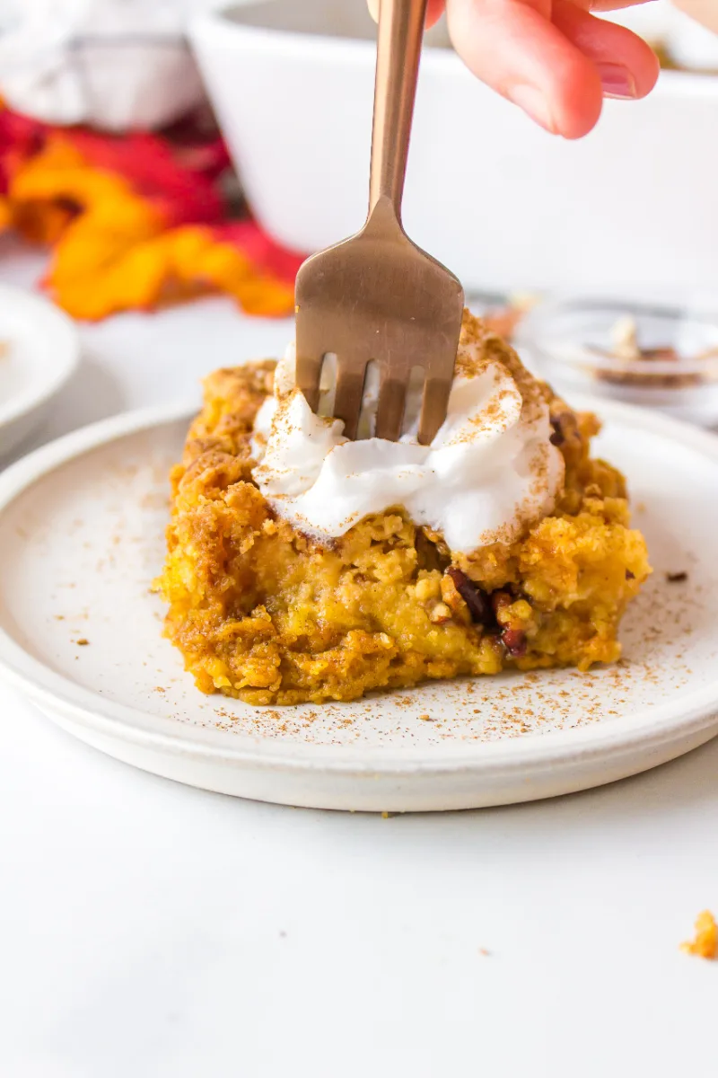 fork into slice of pumpkin dump cake