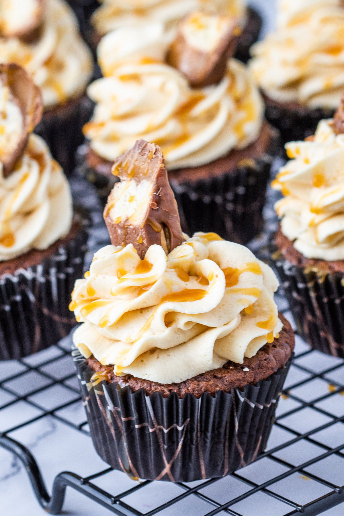 twix bar cupcakes on cooling rack