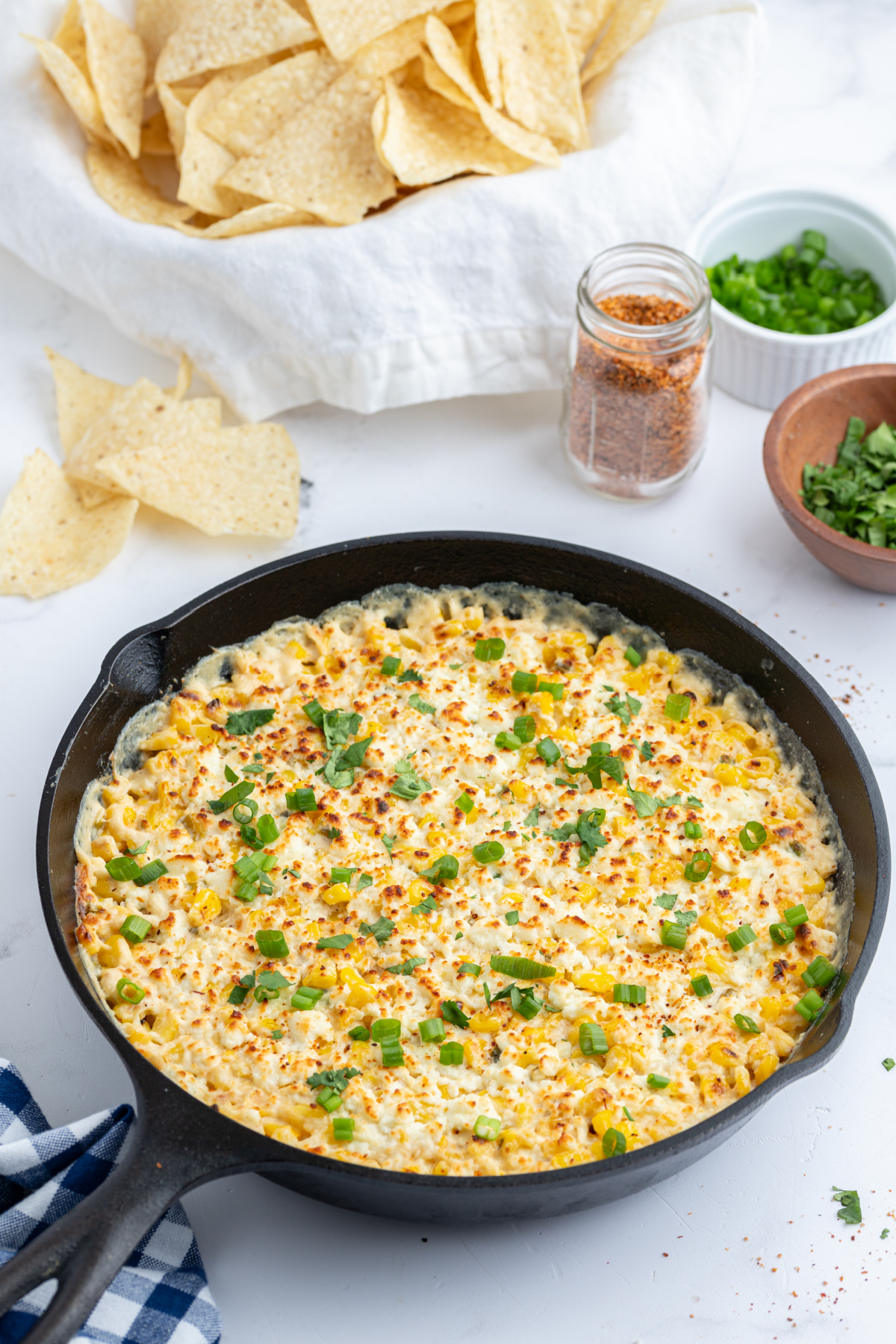 baked elote dip in a cast iron skillet