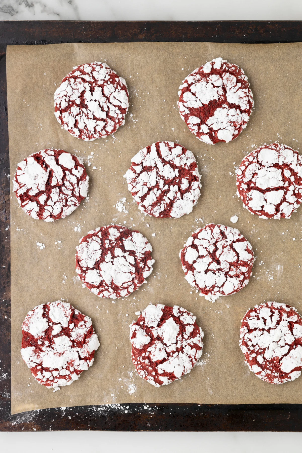 red velvet cool whip cookies on a baking sheet