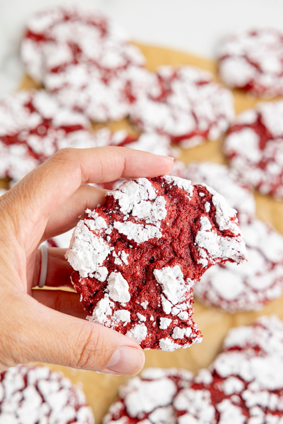 hand holding red velvet cool whip cookie