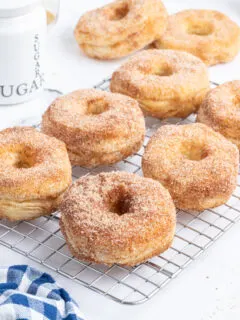 donuts with sugar and cinnamon topping on cooling rack