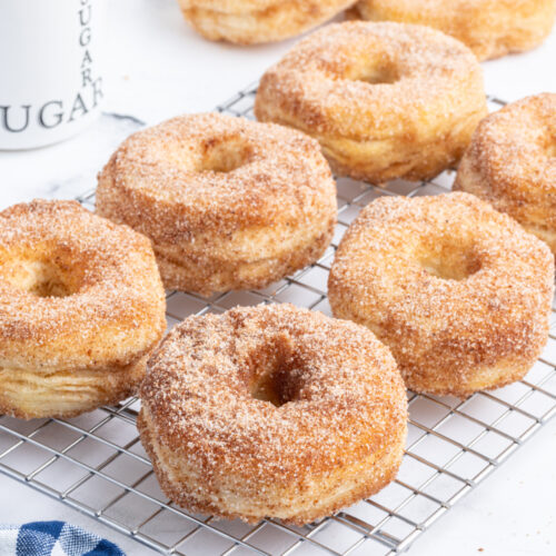 donuts with sugar and cinnamon topping on cooling rack