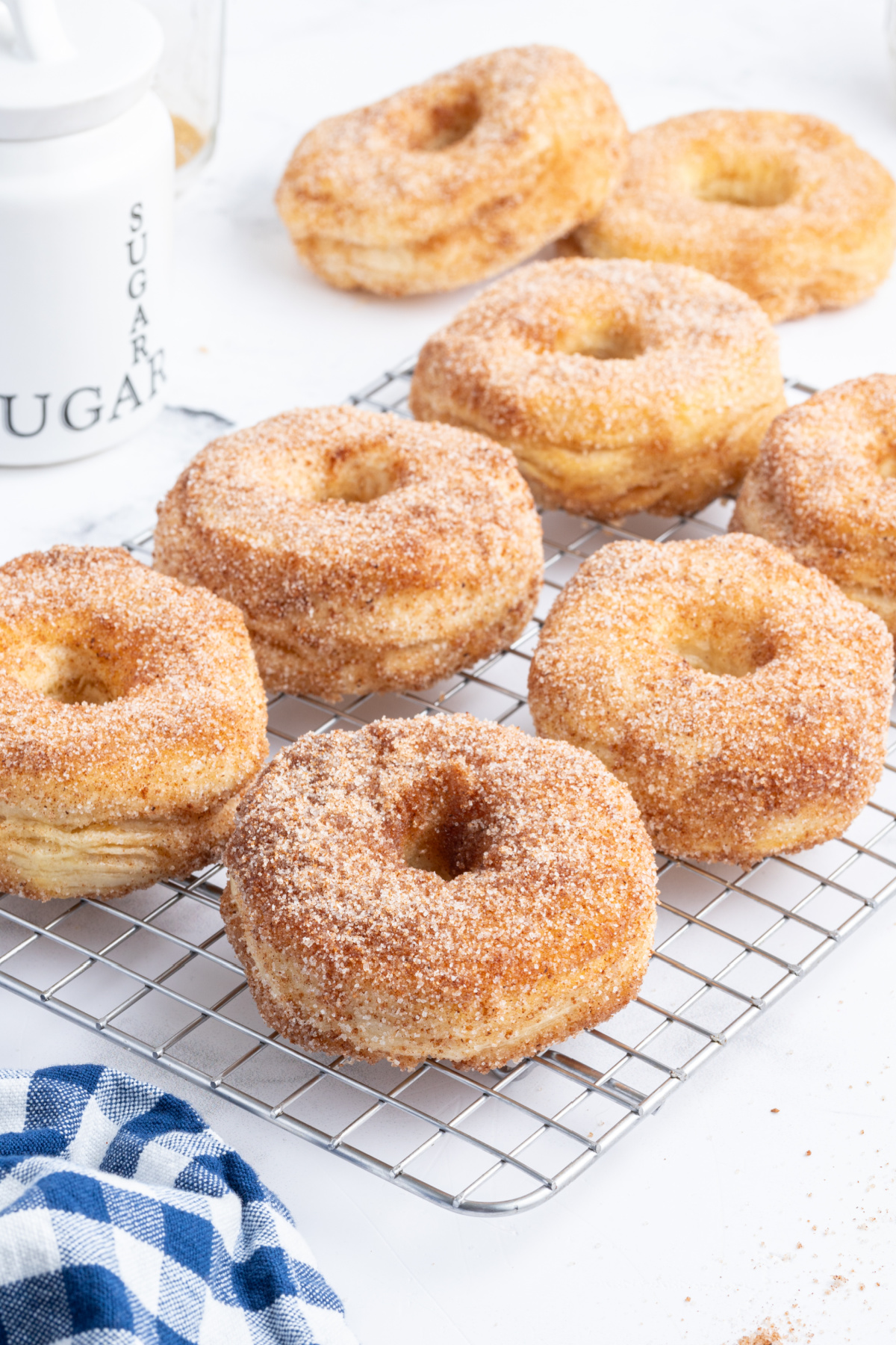 donuts with sugar and cinnamon topping on cooling rack