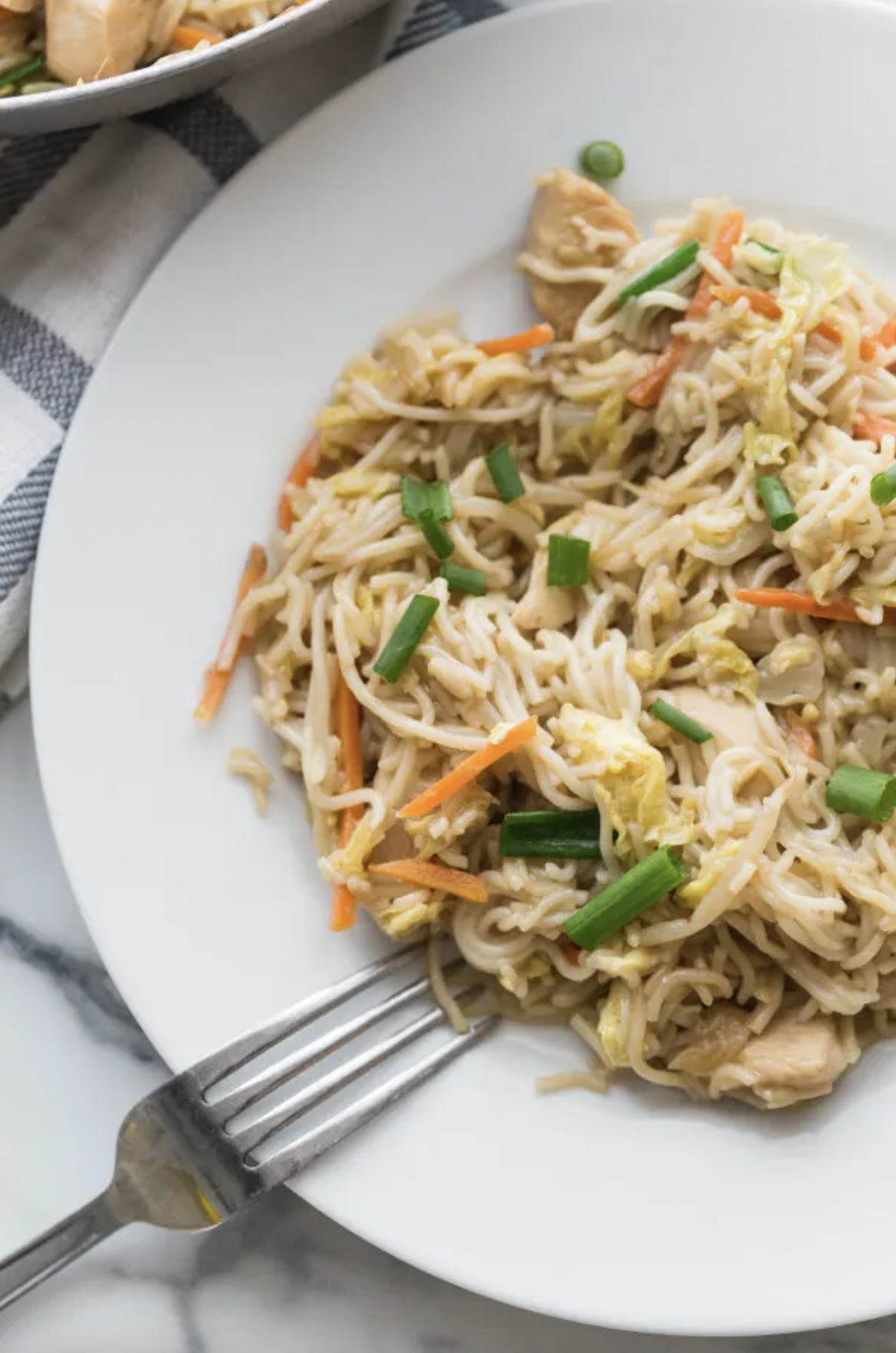 chicken chow mein on a plate with fork