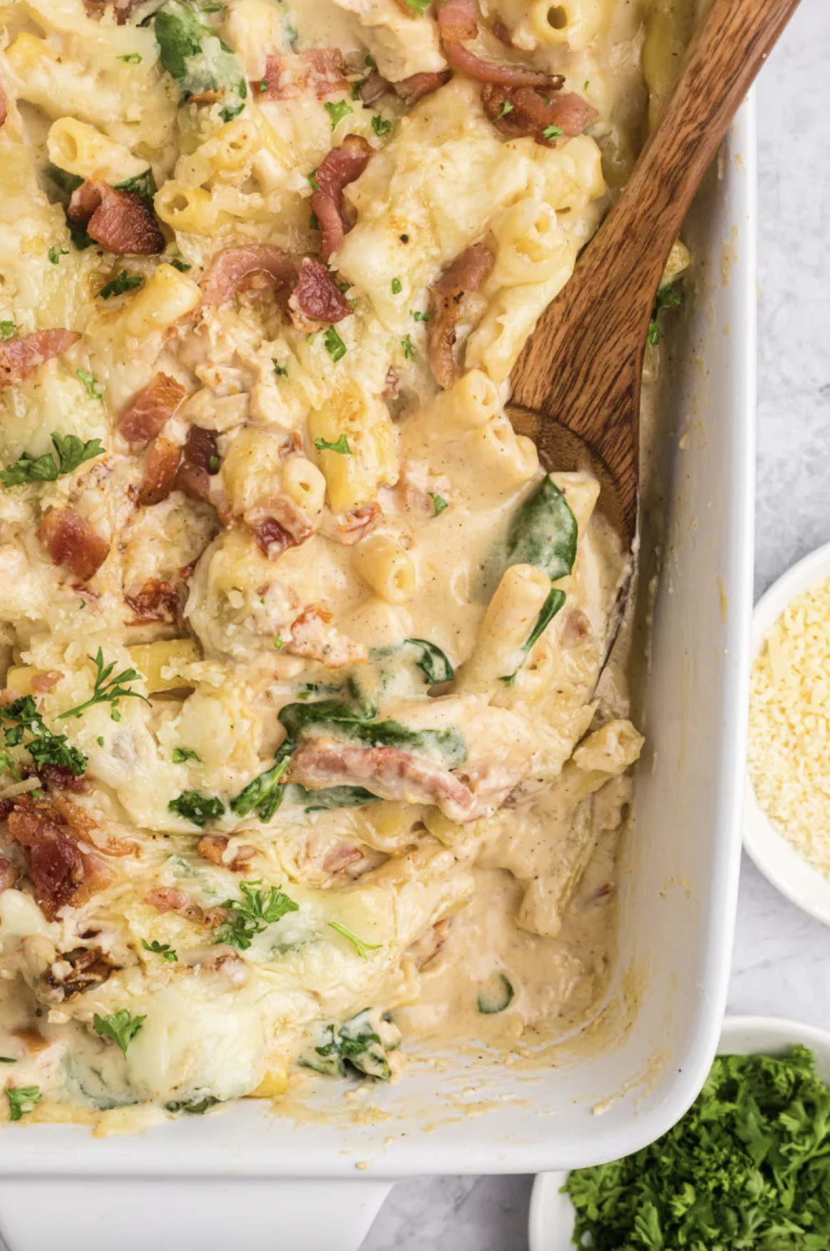 creamy tuscan chicken pasta bake in a baking dish