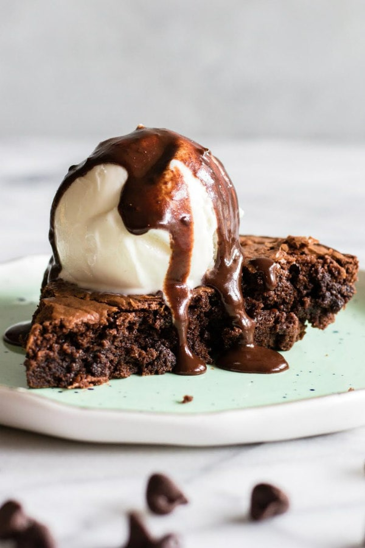 slice of brownie pie with ice cream on top