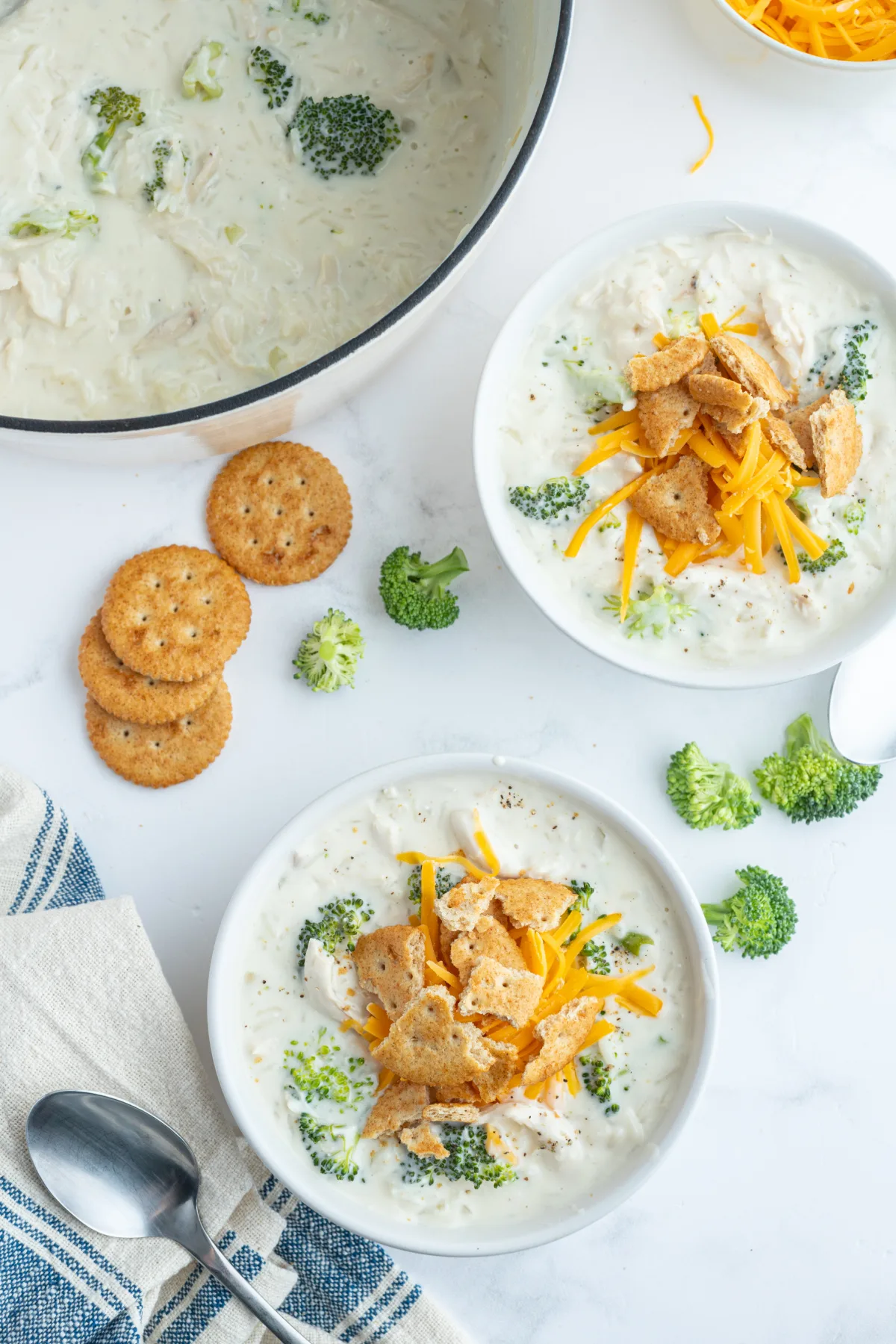 overhead shot of two bowls of creamy chicken broccoli and rice soup