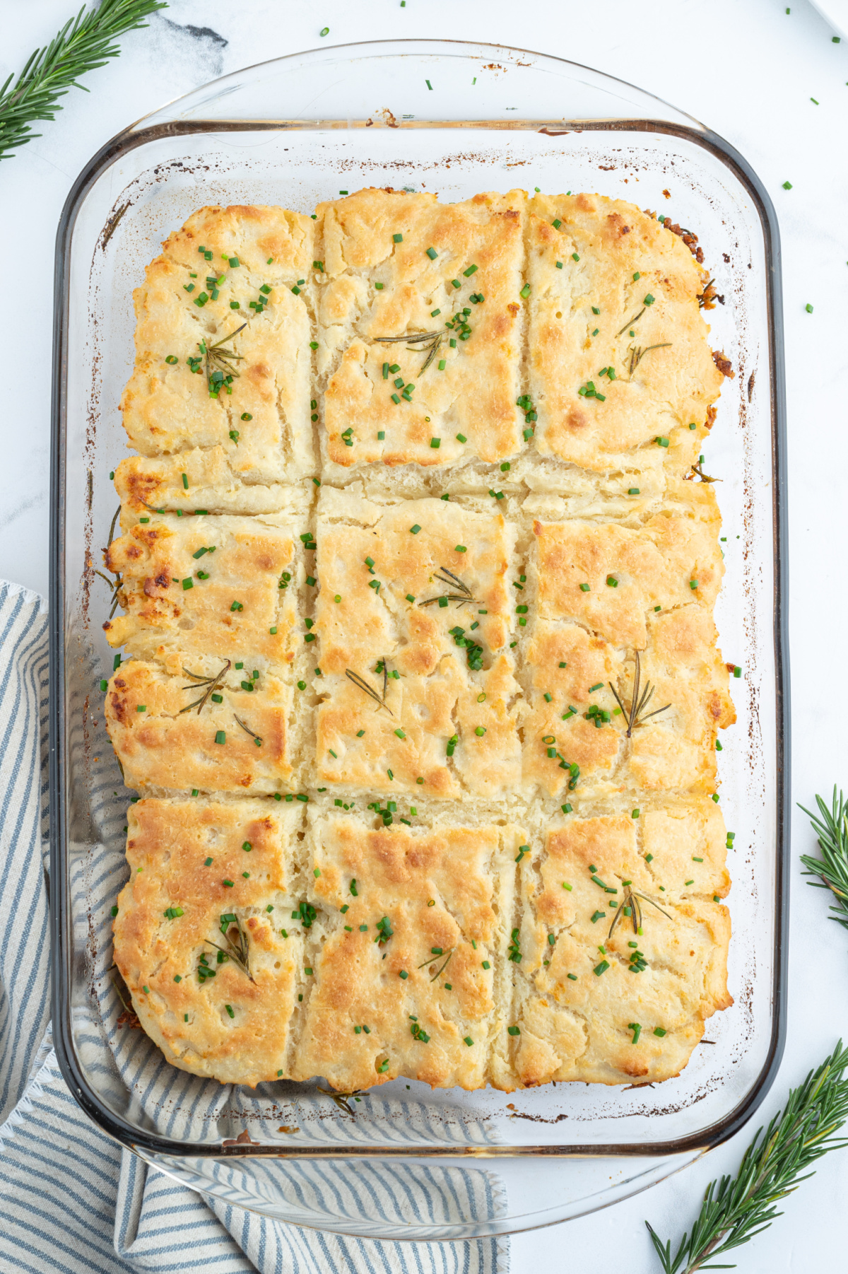 overhead shot of full pan of rosemary garlic butter bath biscuits