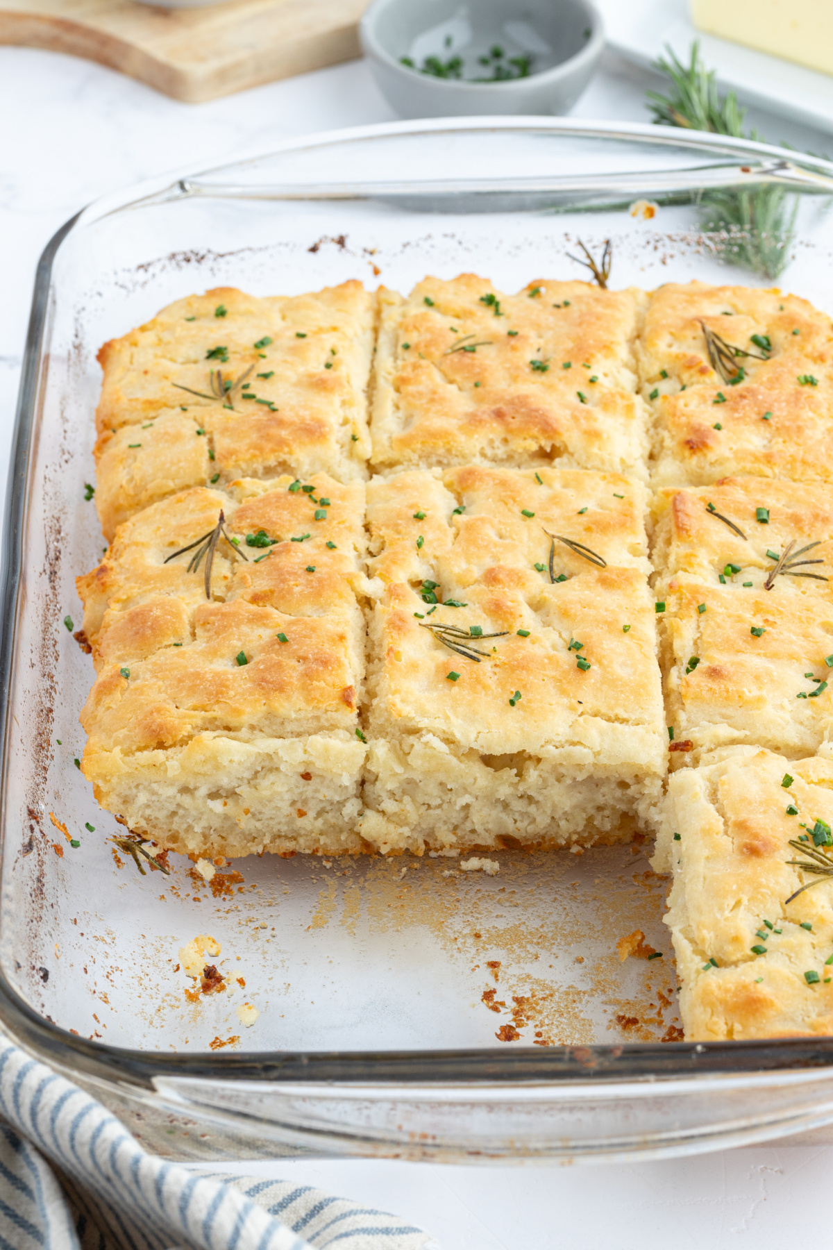 pan of rosemary garlic butter bath biscuits with a few taken out