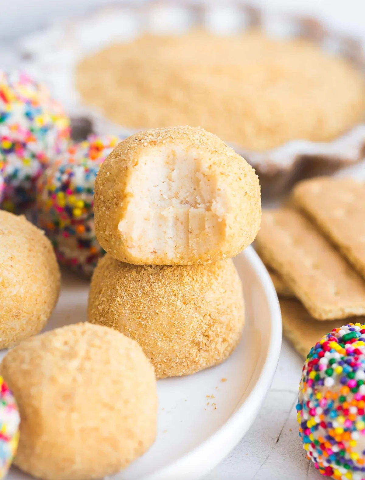 no bake cheesecake balls, one with bite taken out