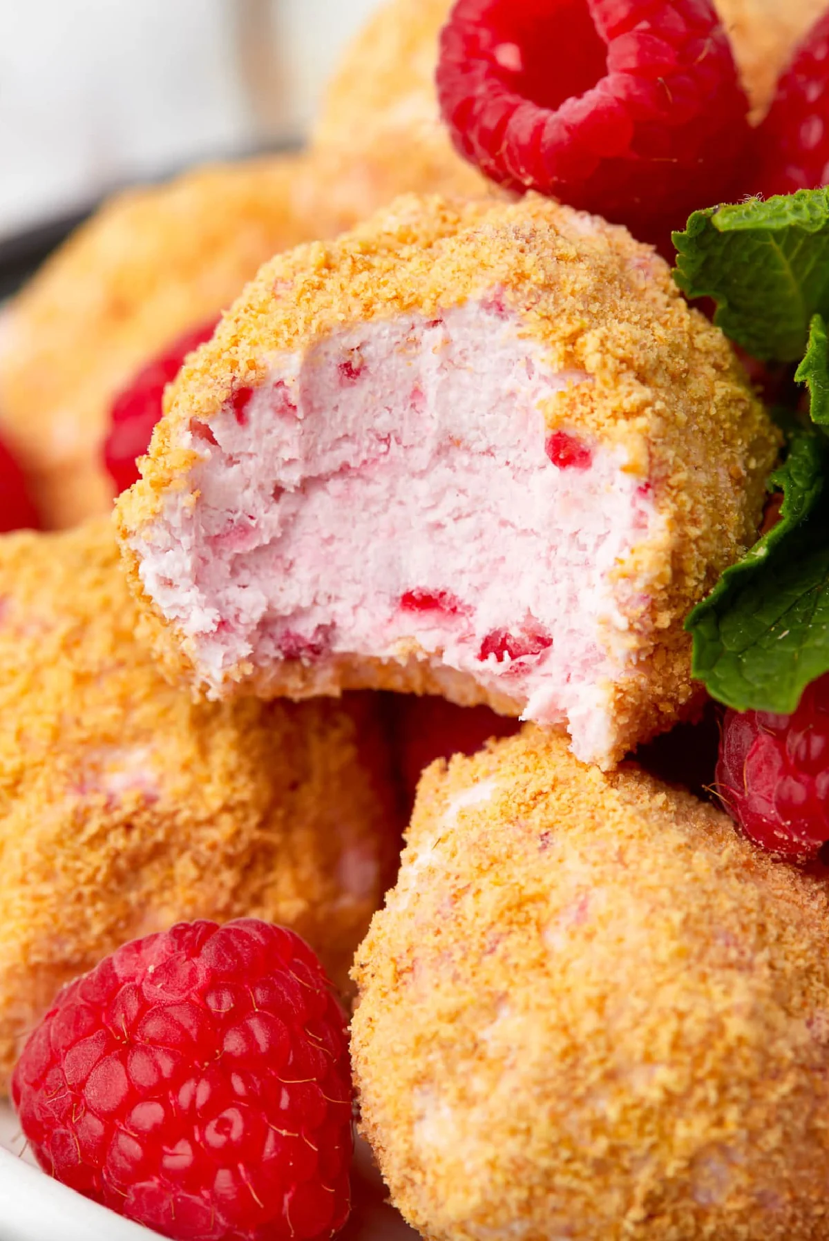 no bake raspberry cheesecake bites one with bite taken out of it