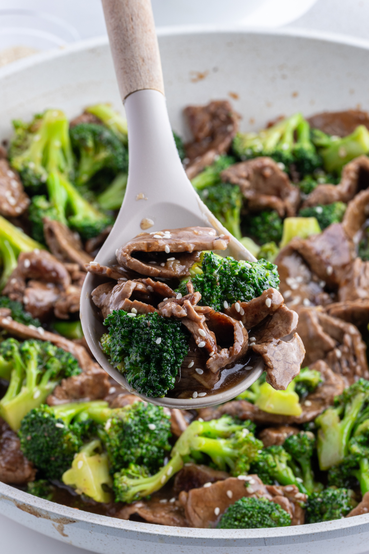 spoon in pan of beef and broccoli stir fry