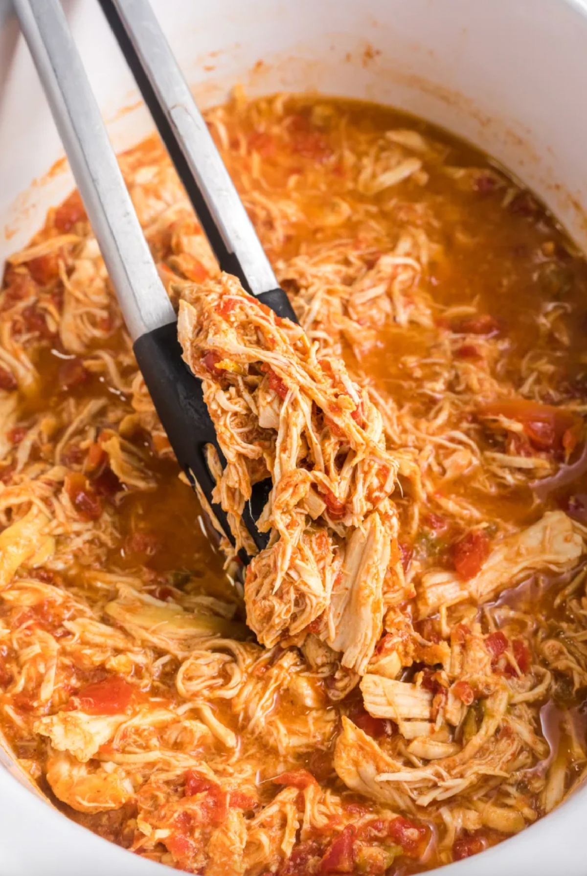 slow cooker mexican chicken with tongs