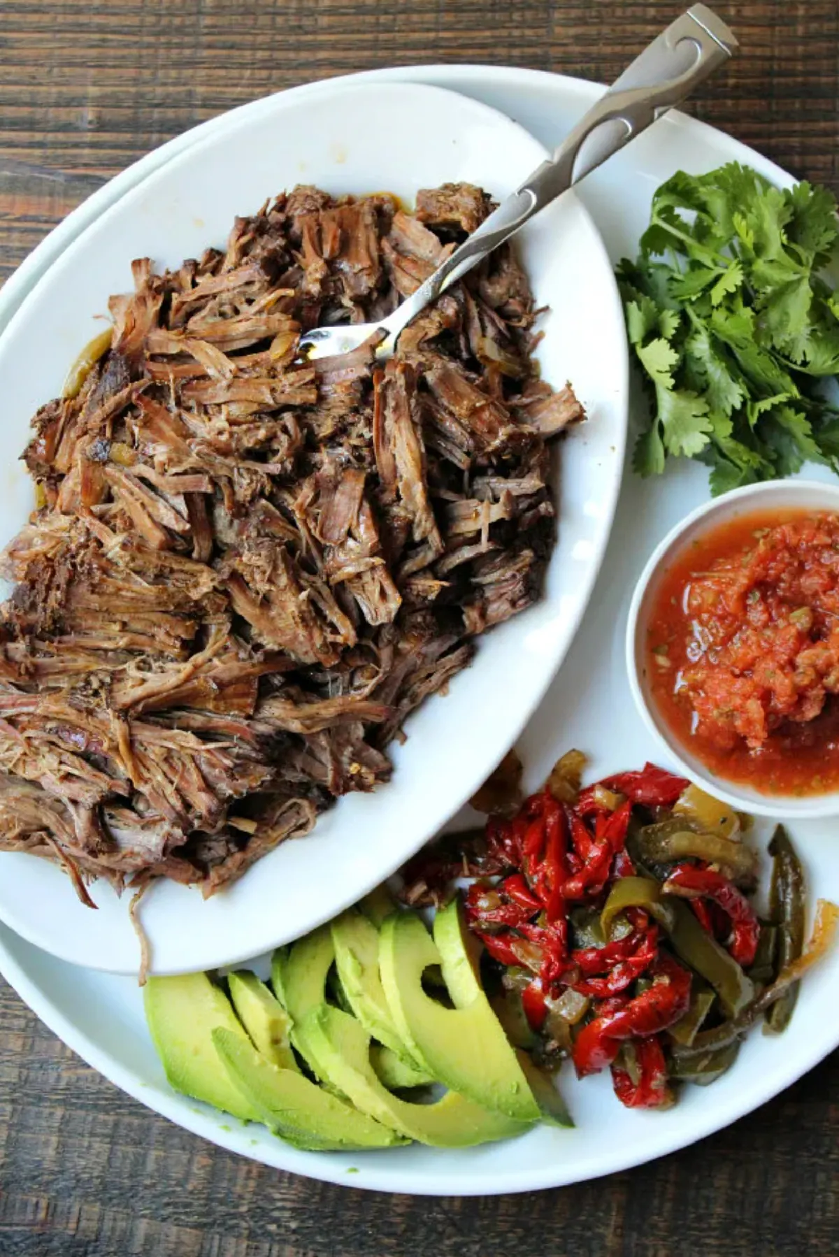 platter of steak fajitas with fixings