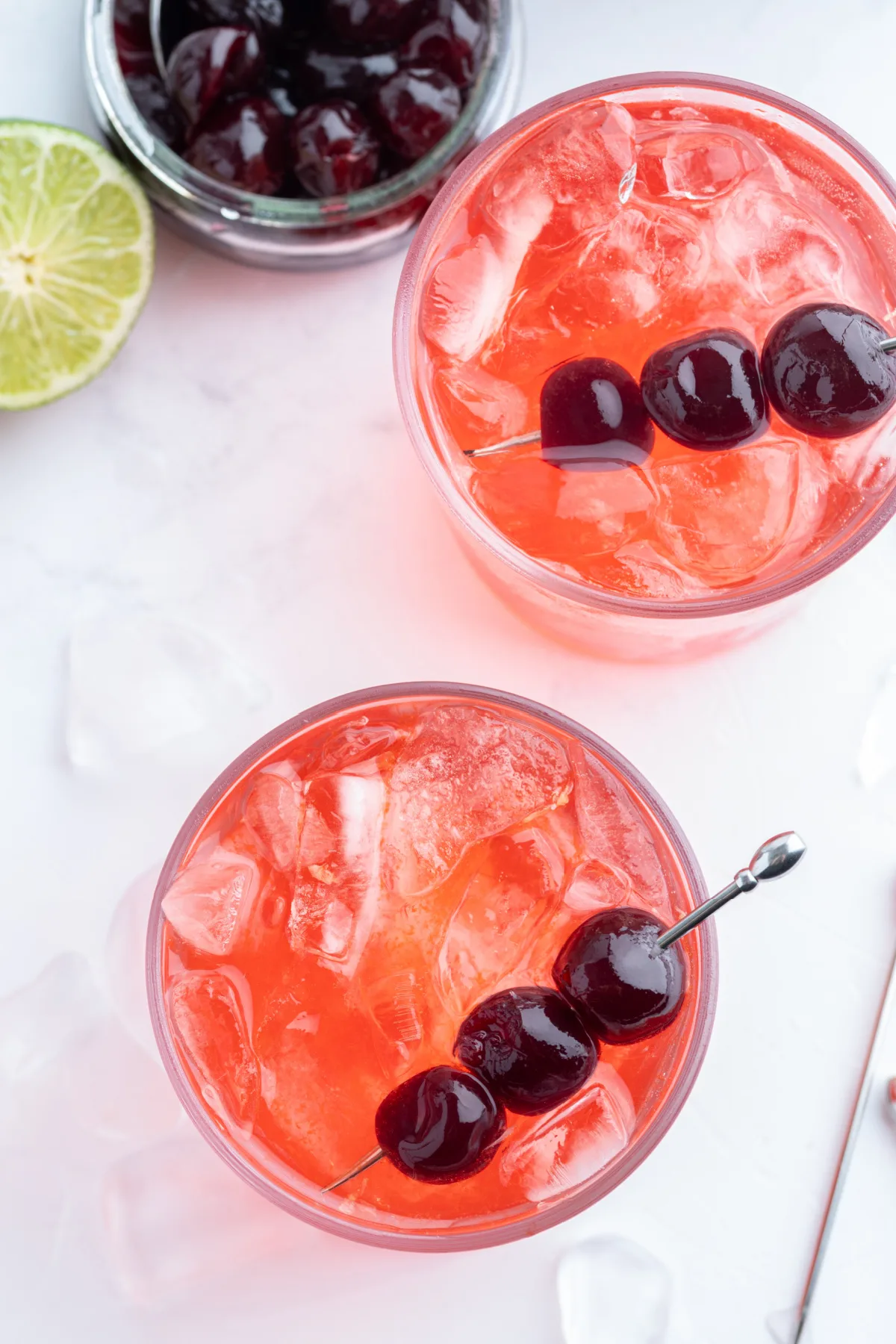overhead shot of tequila shirley temples with cherry garnishes