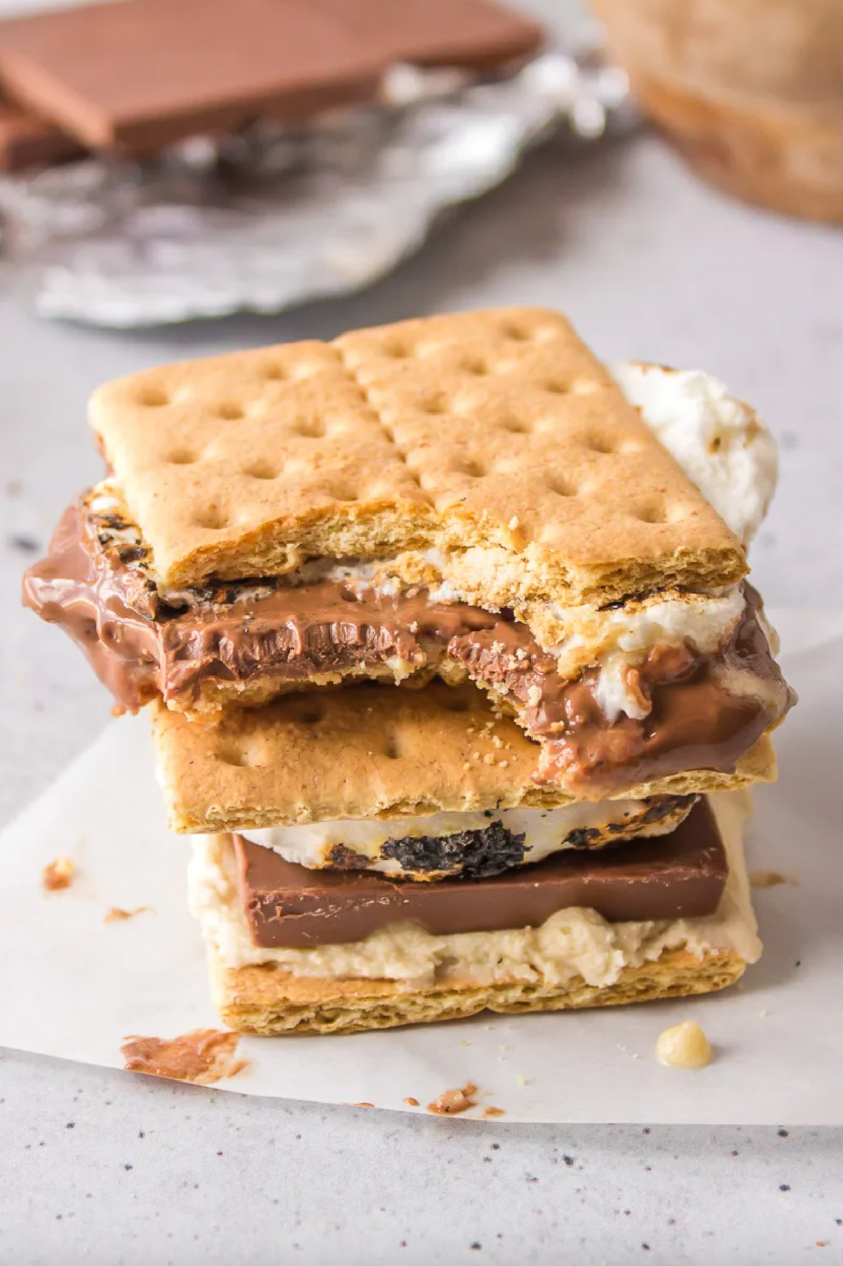 21 Impressive and Easy Summer Dessert Recipes collection on RecipeBoy.com two cookie dough s'mores stacked with top one bite taken out