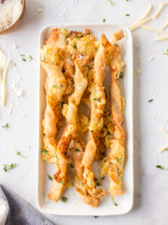 cheese straws displayed on white dish