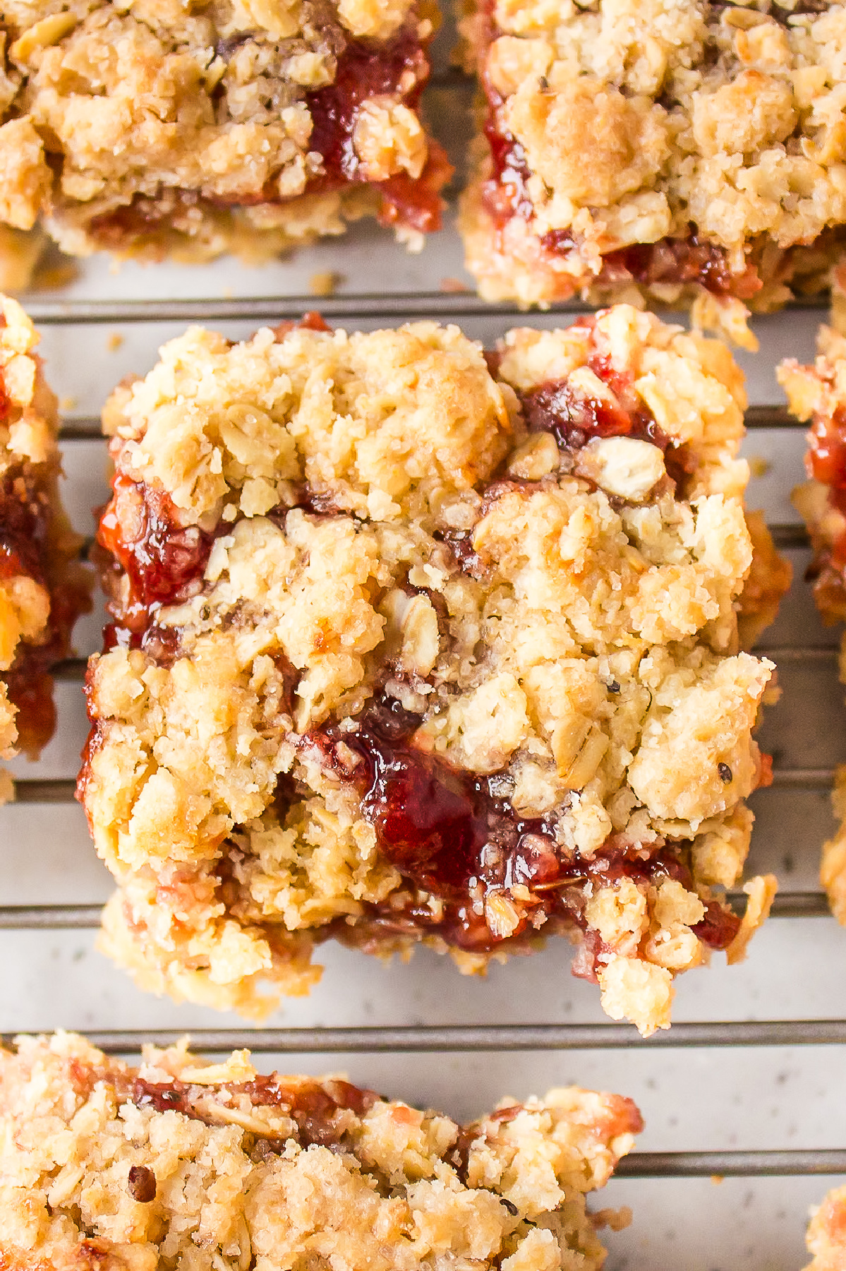 close up raspberry oatmeal bar on rack