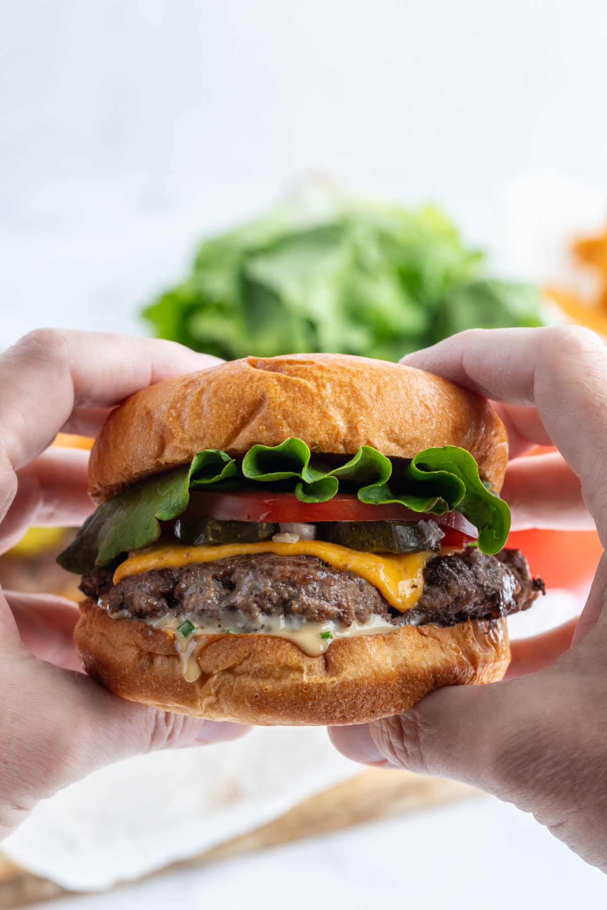 hands holding stovetop smash burger