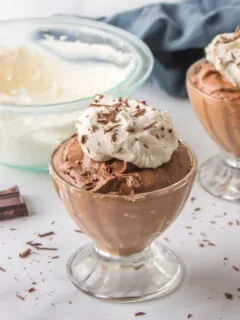 glass of chocolate mousse with whipped cream on top