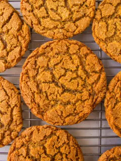 crackle top molasses cookies on a cooling rack