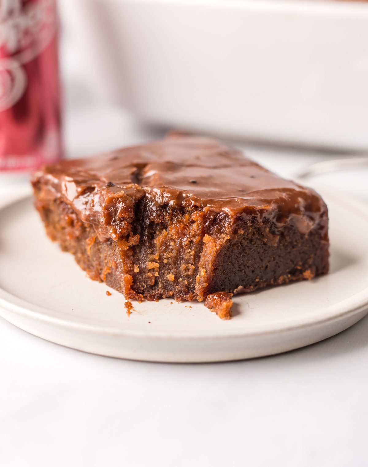 dr. pepper cake on plate with bite taken out of it