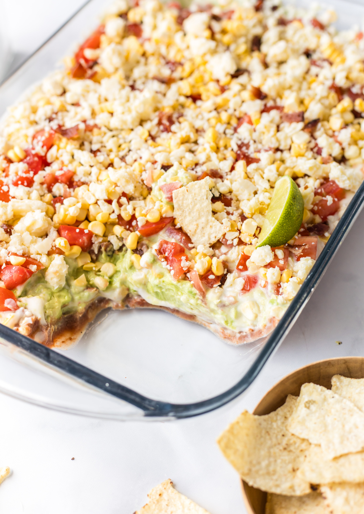 7 layer mexican dip with portion taken out of it